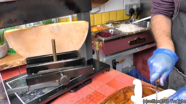 Yummy Swiss Raclette. Warm Melted Swiss Cheese With Egg And Potatoes. London Street Food