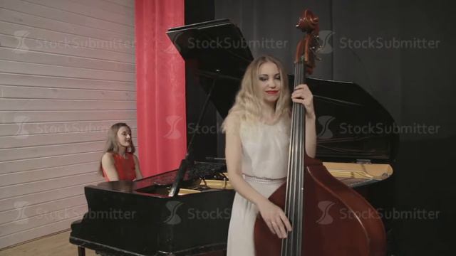Two girls playing musical instruments. Piano and doublebass смотреть онлайн