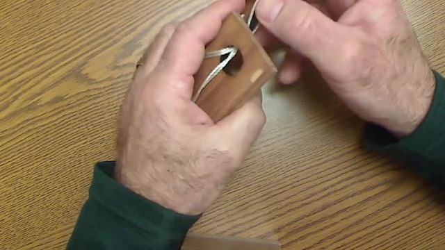 Try this wooden puzzle: Separate the string from the block without cutting ot or breaking it. смотреть онлайн