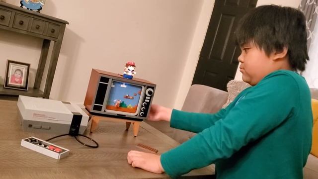 Eyan playing with his Lego Nintendo Entertainment System смотреть онлайн
