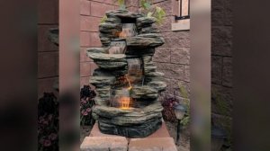 Декоративный фонтан, водопад на садовом участке. Decorative fountain, waterfall in the garden