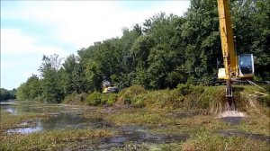 Длиннорукий экскаватор Kobelco проводит дноуглубительные работы