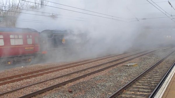 Black 5 44871 departs Huntingdon Station in full steam as an LNER Azuma makes a sudden appearance